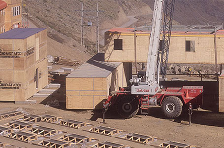 Construcción de una vivienda modular en un terreno montañoso, donde se observa una grúa levantando paneles de una casa prefabricada. Los módulos están alineados y listos para ser ensamblados. Tecno Fast Home.
---
Proceso de montaje de una casa modular en un sitio de construcción, con una grúa en acción, levantando secciones de una vivienda prefabricada. La infraestructura muestra un diseño eficiente y práctico. Tecno Fast Home.
---
Vista aérea de la edificación de una segunda vivienda, con módulos de madera apilados y una grúa que facilita el ensamblaje. El entorno natural resalta la versatilidad de las casas modulares. Tecno Fast Home.